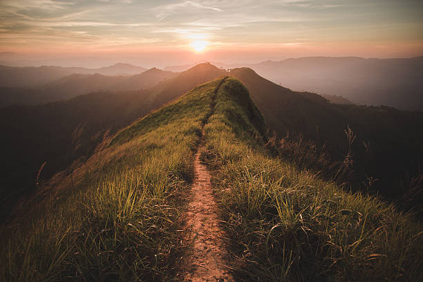 mountain The way of climax. Mountain slope have a way for walk. Background is sunset. climbing up a hill stock pictures, royalty-free photos & images