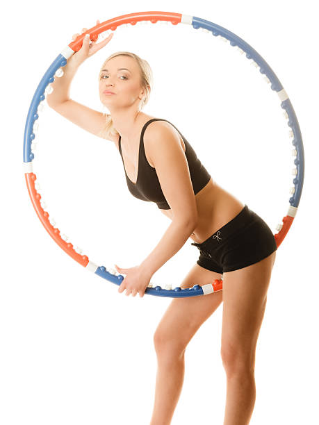 istock sporty fit girl doing exercise with hula hoop. 535377377