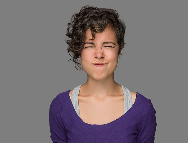 Disgusted Young Woman Disgusted young woman holding her breath,studio shot holding nose stock pictures, royalty-free photos & images