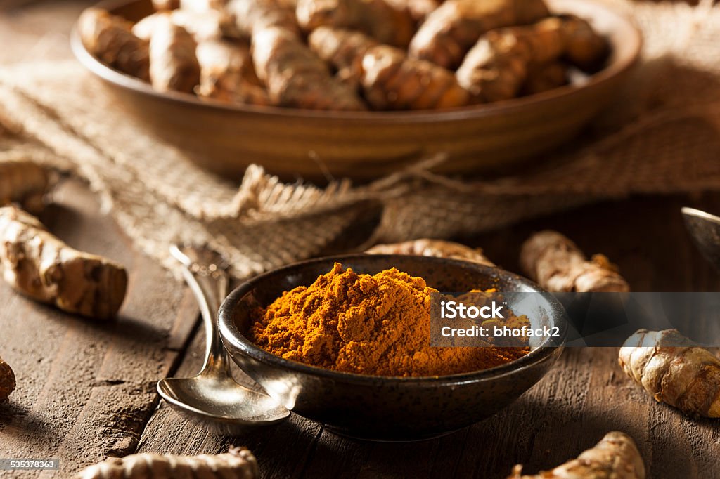 Raw Organic Turmeric Spice Raw Organic Turmeric Spice in a Bowl 2015 Stock Photo