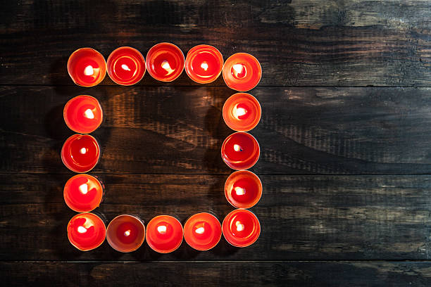 istock glowing small red candles arranged in square 535396930