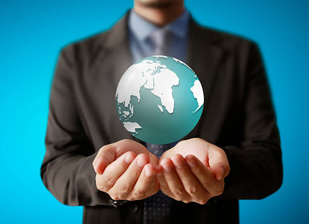 istock holding a glowing earth globe in his hands 535397055