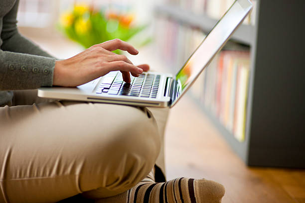 istock Young woman with laptop in home interior 535397817