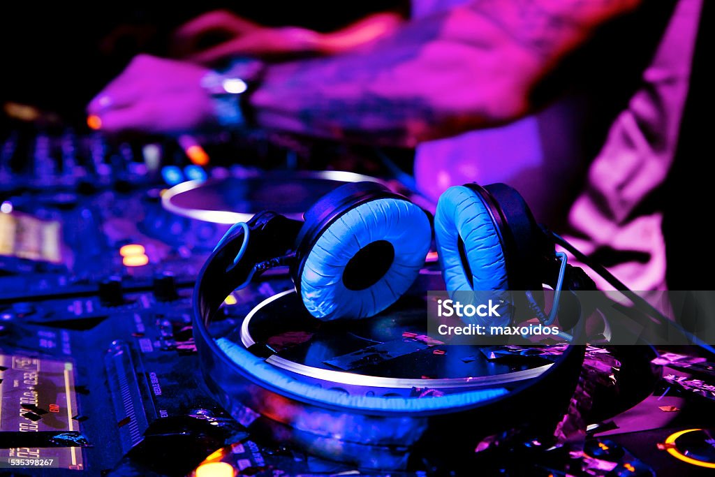 Dj playing the track Dj mixes the track in nightclub at party. DJ headphones 2015 Stock Photo