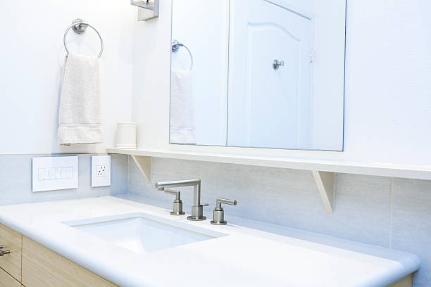 Contemporary Bathroom Design in Residential Home with Vanity andBath Sink A modern bathroom is pictured with vanity cabinets, mirror bath sink and counter. bathroom sink photos stock pictures, royalty-free photos & images