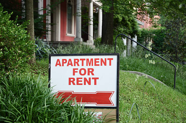 Rental Sign Apartment for rent sign displayed on residential street. Shows demand for housing, rental market, landlord-tenant relations. house rental stock pictures, royalty-free photos & images