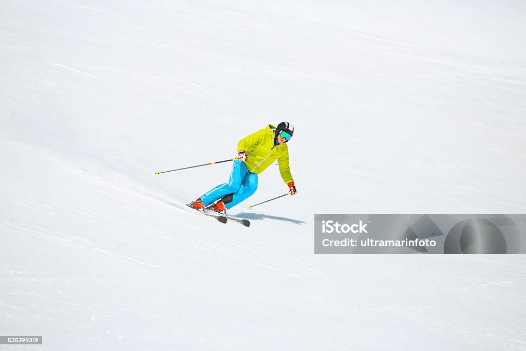 Men snow skier skiing, enjoying on ski resorts  Winter sport Men snow skier, equipped with modern carving ski equipment. Skiing with a smile enjoying on sunny ski resorts. Skiing carving at high speed.  Snow in the foreground, snow in the background, applicable for all ski resorts and locations. Shot with Canon 5DMarkIII, developed from RAW,  Adobe RGB color profile. Shallow DOF  for soft background. 2015 Stock Photo