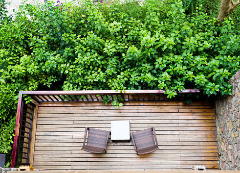 High angle view of two chairs in a balcony garden.