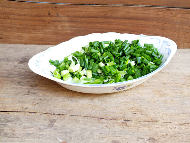 istock fresh spring onion chopped green onions on wooden background 535399502