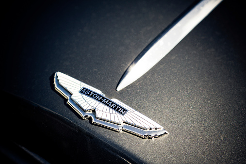 Shetland Isles, Scotland, UK - June 3, 2012: Bonnet detailing of an Aston Martin classic car.  Photographed in an artistic style with a heavy vignette to create intensity and the sun reflecting off the chrome to add a sparkle to the image.