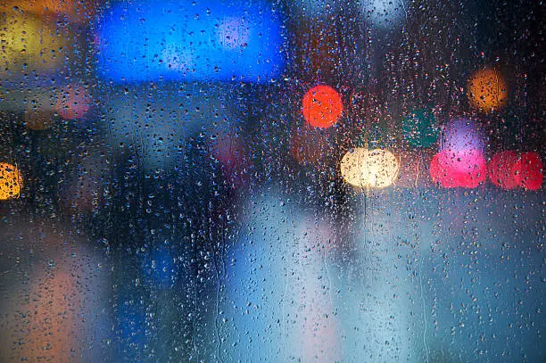 Photo of Rain drops on the window with traffic light. Toronto