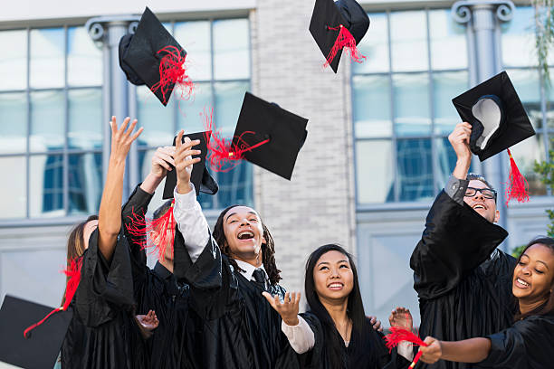 istock Group of students at graduation, tossing caps 535402531