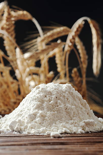 istock Pile of flour at wheat ears background 535402544