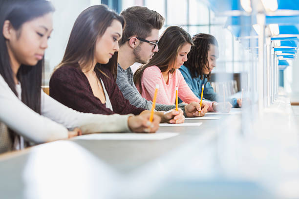 istock Group of teenagers taking a test 535402567
