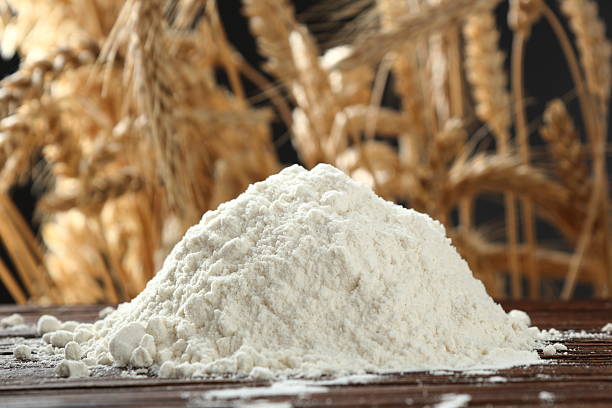 istock Pile of flour at wheat ears background 535402634