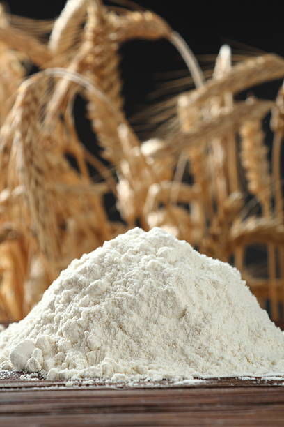 istock Pile of flour at wheat ears background 535402650