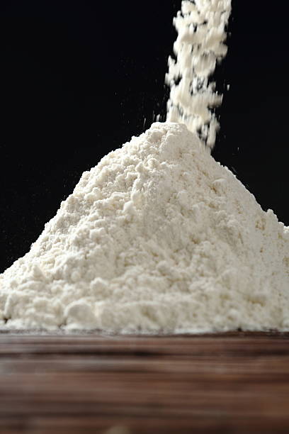 istock Pouring flour at black background 535402670