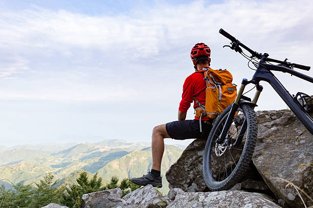 istock Mountain biker looking at view in autumn mountains 535404764