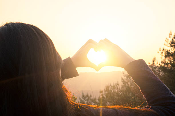 istock woman making heart shape finger frame 535405300