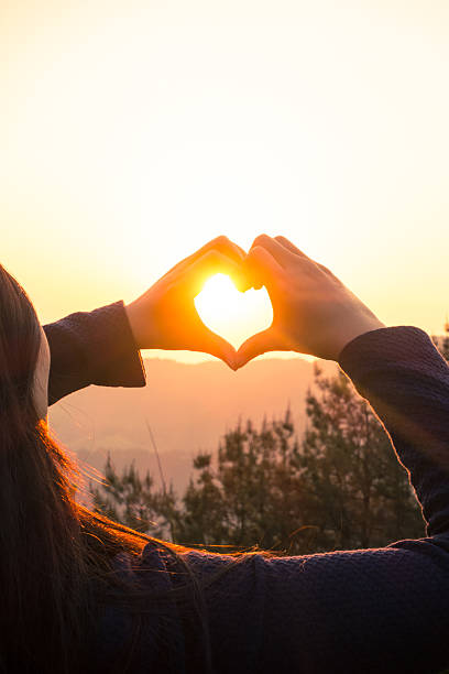 istock woman making heart shape finger frame 535405326