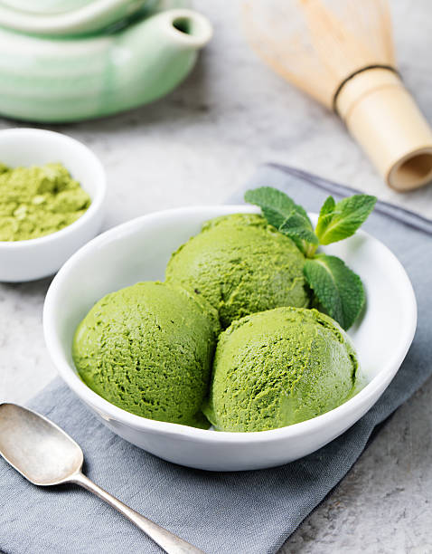 istock Green tea matcha ice cream scoop in white bowl 535405556