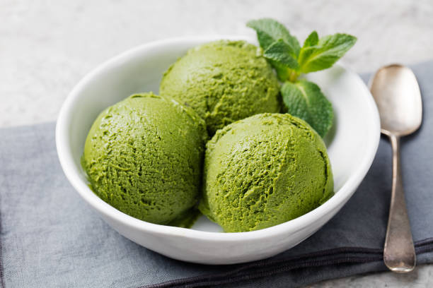 istock Green tea matcha ice cream scoop in white bowl 535405648