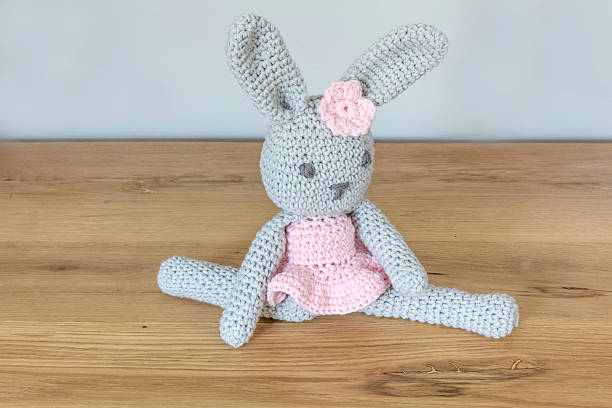 Handmade Crochet Toy Rabbit Sitting In Ballet Pose stock photo