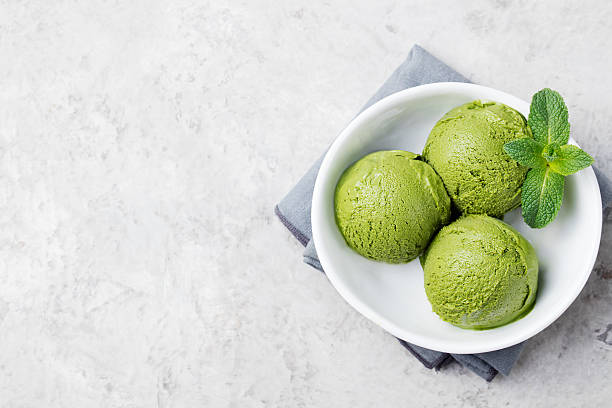 istock Green tea matcha ice cream scoop in white bowl 535405806