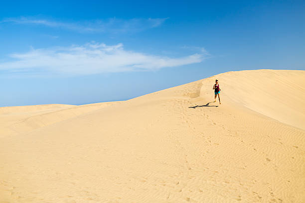 istock Woman running on desert dunes 535405964