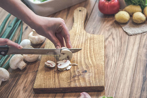 istock Woman chopping mushrooms 535410800
