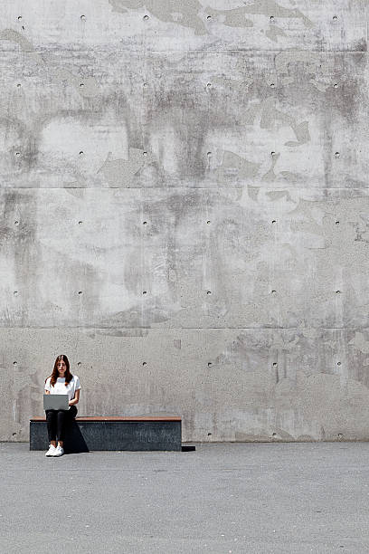istock girl, laptop, concrete 535411896