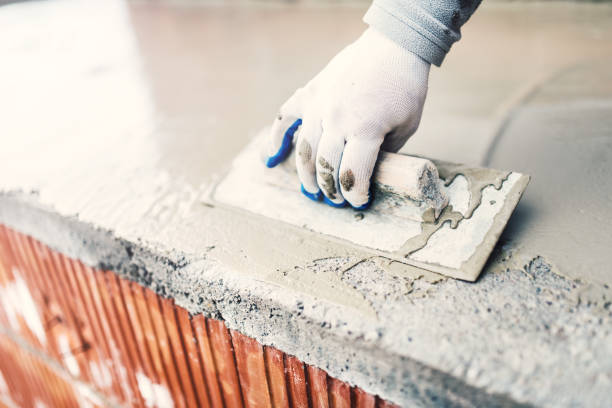 istock protective material against water on house building. worker waterproofing cement 535411948