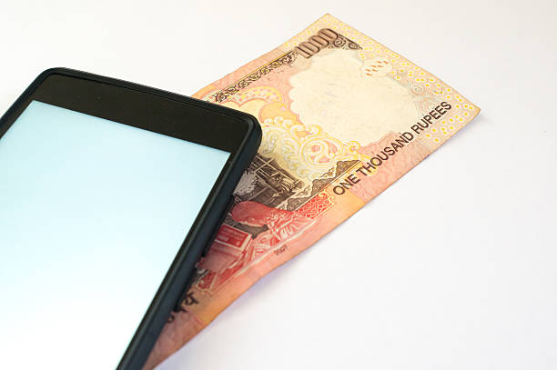 istock Indian money with mobile phone on white 535412162