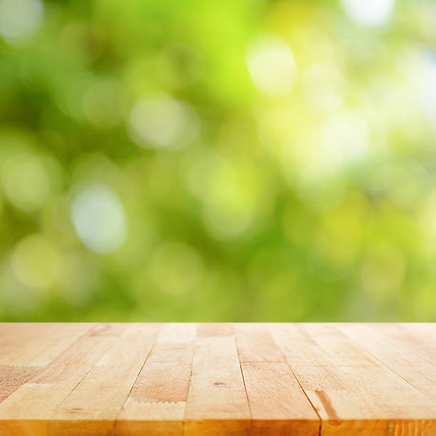 istock Wood table top on blur green abstract background 535413095