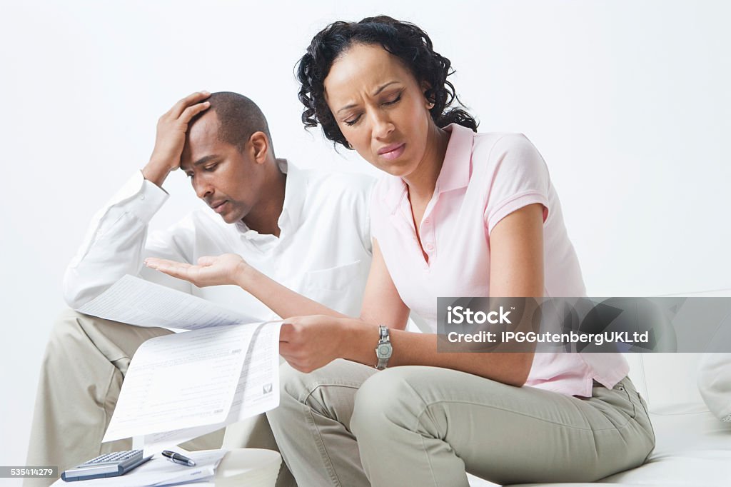 Worried Couple With Domestic Bills Worried African American couple over domestic bills 2015 Stock Photo