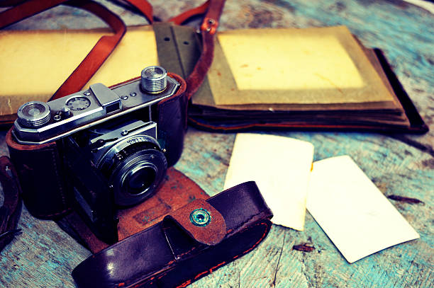 istock Old retro camera on vintage wooden background 535415083