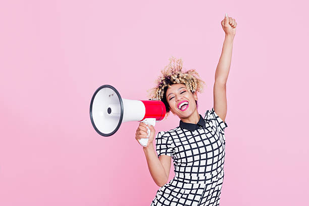istock Afro American young woman shouting into megaphone 535415652