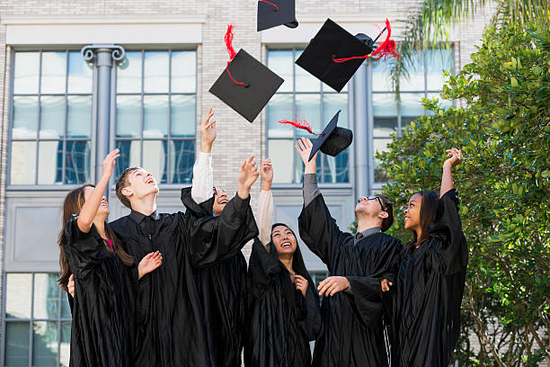 istock Group of students at graduation, tossing caps 535415921