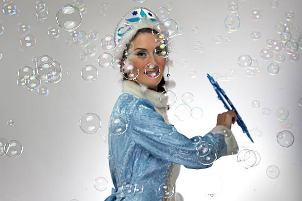 istock Image of snow maiden with soap bubbles 535417529