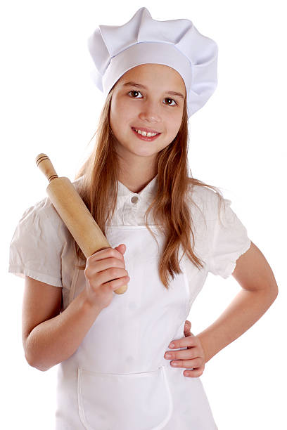 istock Girl dressed as a cook holding a rolling pin 535417833