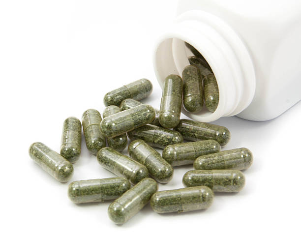istock herb capsules spilling out of a bottle 535419300