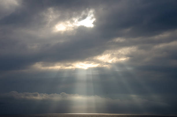 istock Dark Clouds with Sunbeams Over the Sea 535419977