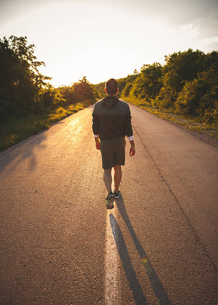 istock Young man walking on the road 535421014