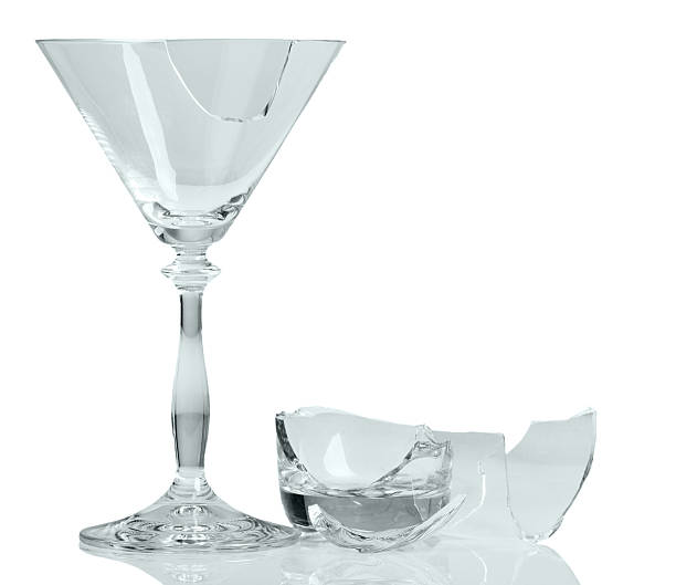 istock Fragments of broken wine glass close-up isolated on white . 535422584
