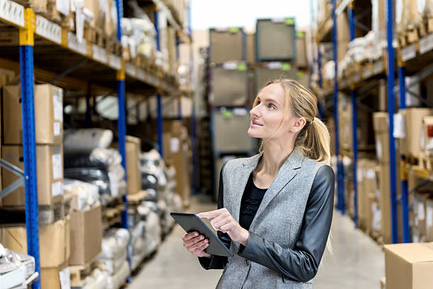 istock Blond female worker touching digital tablet at warehouse 535423198