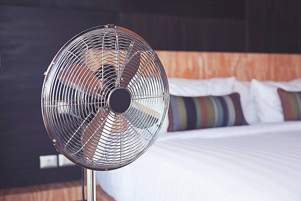 electric fan in the room Old electric fan near the bed in the room electric fan photos stock pictures, royalty-free photos & images