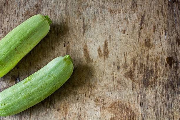 istock Fresh zucchini On wooden background. 535423850