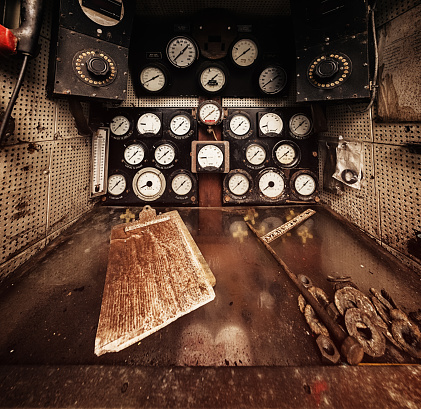 The dirt covered main control panel of an abandoned twin engined tugboat.