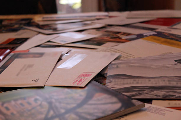 Table Covered with Junk Mail Envelopes stock photo