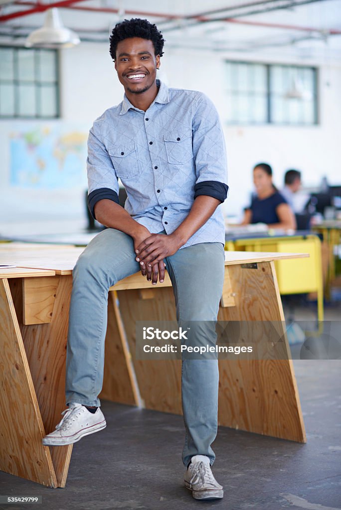 The look of confidence Full lenght portrait of a handsome young businessman sitting on a desk in his officehttp://195.154.178.81/DATA/istock_collage/0/shoots/784845.jpg 2015 Stock Photo